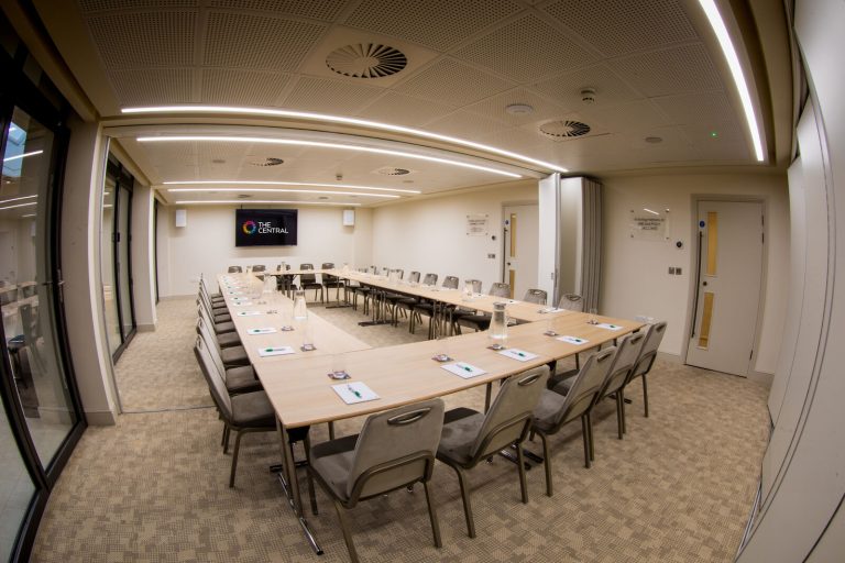 Interior space of a conference room with a U shaped table at The Central